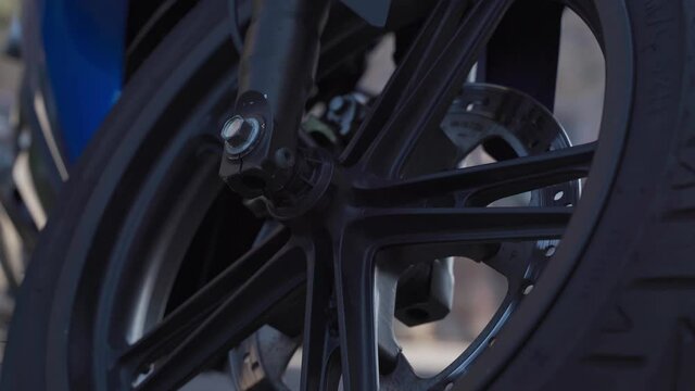 Front motorcycle wheel, brake calipers, brake disc, cloudy
