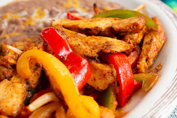 A closeup view of a plate of chicken fajitas.
