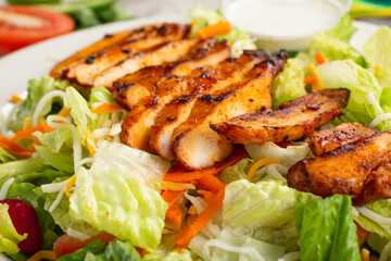 A closeup view of a grilled chicken salad.