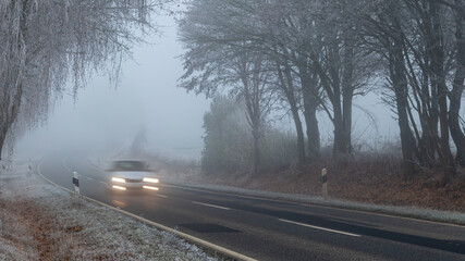 car driving through fog in winter
