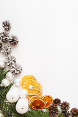 Christmas, winter, new year composition. Fir tree branches, pine cone, dried oranges on white background. Flat lay, top view, copy space