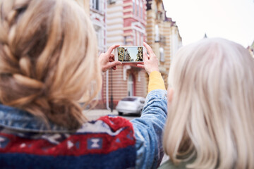 Woman taking photo of the great amazing building