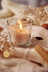 Burning candle and christmas decorations, top view. Winter cozy home and hygge concept