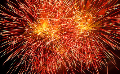 holiday fireworks of red and golden color on a black sky background, close up