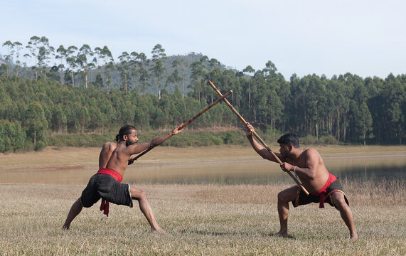 Indian fighters with bamboo sticks performing Kalaripayattu Marital art demonstration outdoors in Kerala state, South India	
