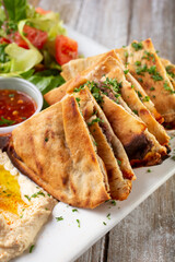 A view of a plate of beef arayes bites.
