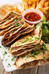 A view of a plate of beef arayes bites.
