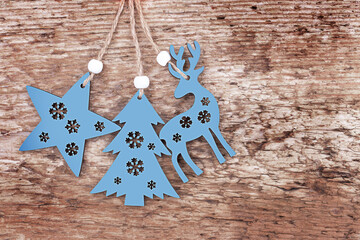Christmas and New year background. Wooden Christmas decorations: deer, tree, star  on a wooden...