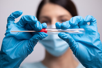 Medical healthcare nurse holding Coronavirus COVID-19 swab test kit, PPE protective mask and...