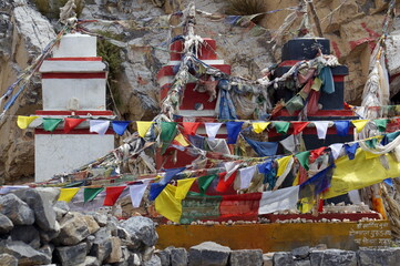 Traditional Buddhist chortens stand in the Himalayan mountains in the place of worship of the gods, with garlands of flags. Upper Mustang. Nepal.