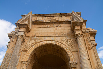Fototapeta na wymiar The Arch of Septimius Severus in the archaeological site of Leptis Magna, Libya
