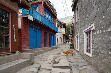 A narrow street in a stone-paved road in the village of Kagbeni, of the Kingdom Mustang, Nepal. In Kagbeni there is a checkpoint to the closed zone of Nepal - Upper Mustang.