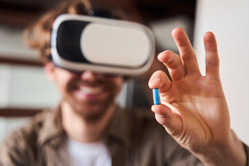 Man holding a pill at his fingers