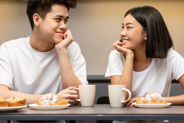 Happy Japanese Couple Drinking Coffee Smiling Each Other In Kitchen