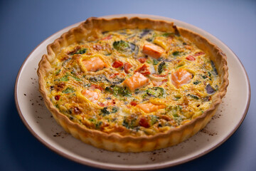 Traditional salmon quiche with broccoli and vegetables