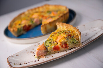 Traditional salmon quiche with broccoli and vegetables