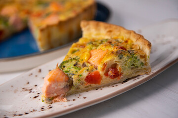 Traditional salmon quiche with broccoli and vegetables