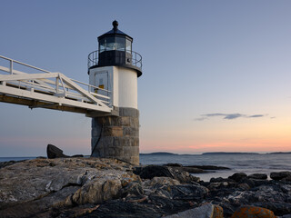 Fototapeta na wymiar The Marshall Point Lighthouse at the entrance to the St. George river and the Port Clyde fishing village in Maine