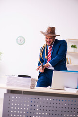 Young businessman cowboy working in the office