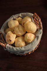Brazilian cheese bread 'pao de queijo' on basket, homemade cheese buns. typical snack from minas gerais. Isolated on Dark Background.
