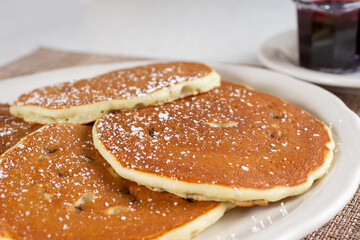 A view of a plate of blueberry pancakes.