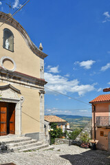 A narrow street among the old houses of Scontrone, a medieval village in the Abruzzo region, Italy.