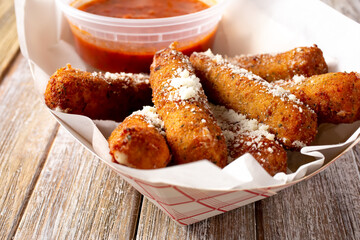 A view of a tray of mozzarella sticks.