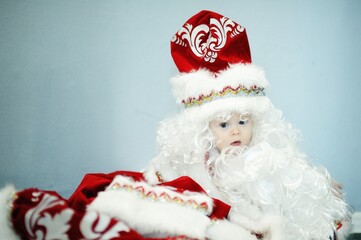 kid in red santa claus costume