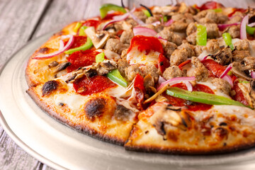 A closeup view of a supreme pizza.