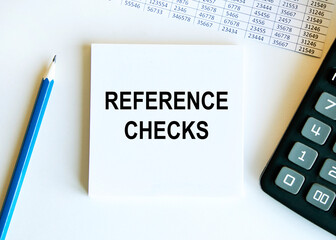 Reference CHECKS text, a calculator, a blue pencil and a report are next to the notes.