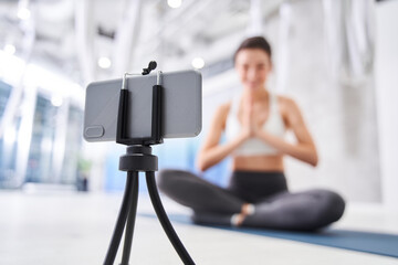 Woman recording her vlog about yoga
