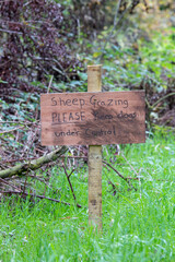 home-made sign telling you Sheep grazing please keep dogs under control