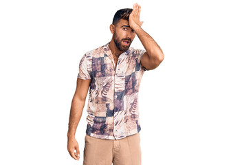 Young hispanic man wearing summer clothes surprised with hand on head for mistake, remember error....