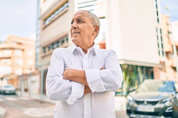 Senior man smiling happy walking at the city.