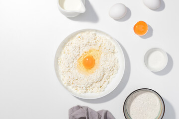 Step-by-step recipe - Cottage cheese, eggs, cream and yougurt on a white background - Flat lay