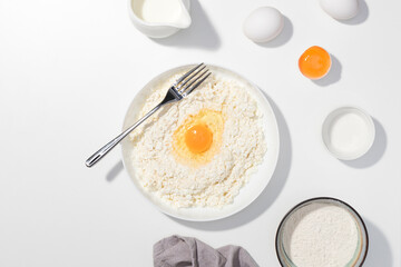 Step-by-step recipe - Cottage cheese, eggs, cream and yougurt on a white background - Flat lay