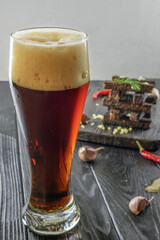 glass of dark beer with crunchy rye croutons