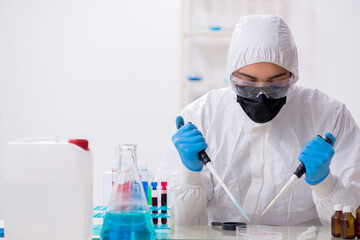 Young male chemist working in medicine lab