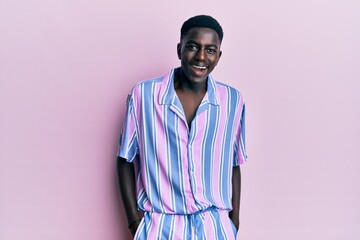 Obraz premium Young african american man wearing casual clothes smiling and laughing hard out loud because funny crazy joke.