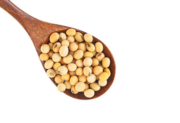 Soybeans in wooden spoon on a white background, top view. Organic raw soybeans. Space for text.