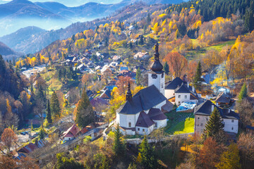 The Spania Dolina village with church and historic buildings in valley of autumn  landscape, Slovakia, Europe. - obrazy, fototapety, plakaty