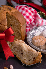 portion of panettone cut on the table with christmas decorations
