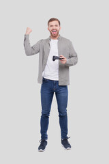 Man Standing with Joystock in Hand Isolated. Man Happy with Game. Man Cheering. © Alex