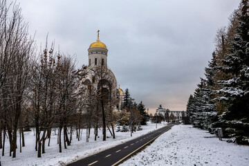 winter landscape in a city park after the first snow at the beginning of winter