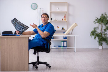 Young male doctor radiologist being unhappy after night shift