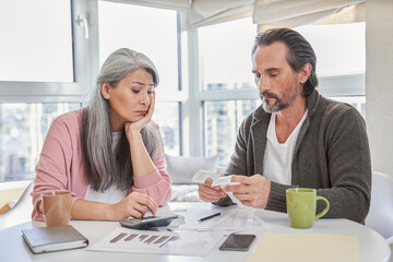 Couple discussing bills at home
