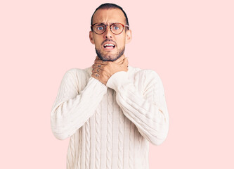 Young handsome man wearing casual clothes and glasses shouting and suffocate because painful...