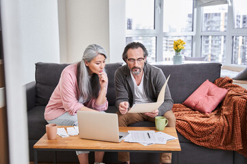 Couple discussing paper documents