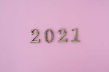 Christmas 2021. Coronavirus new year minimal concept. Flat lay with metal numbers on pink background. top view, copy space