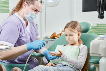 Child to the dentist. Child in the dental chair dental treatment during surgery. Small kid patient...